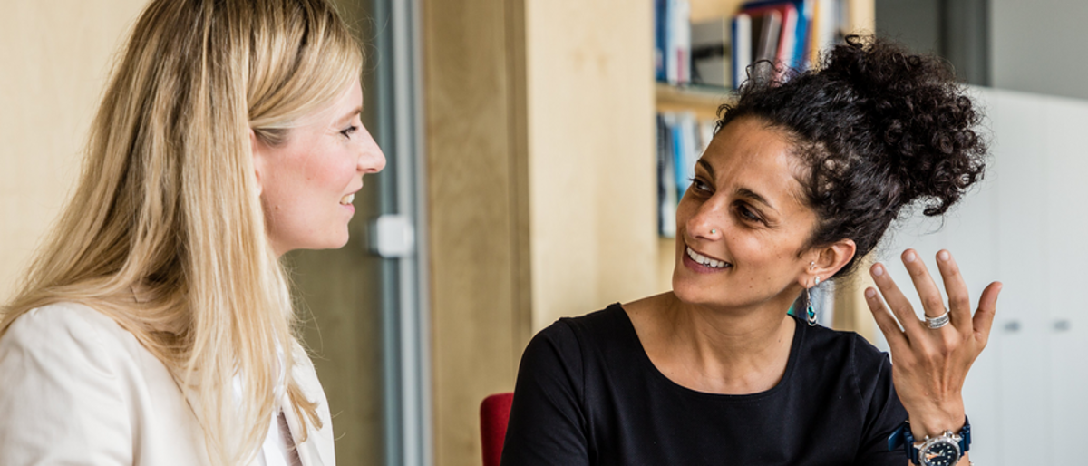 Außenwirtschaftsberater beantworten Ihre Fragen im Einzelgespräch. Zwei Frauen sitzen am Besprechungstisch und sprechen miteinander
