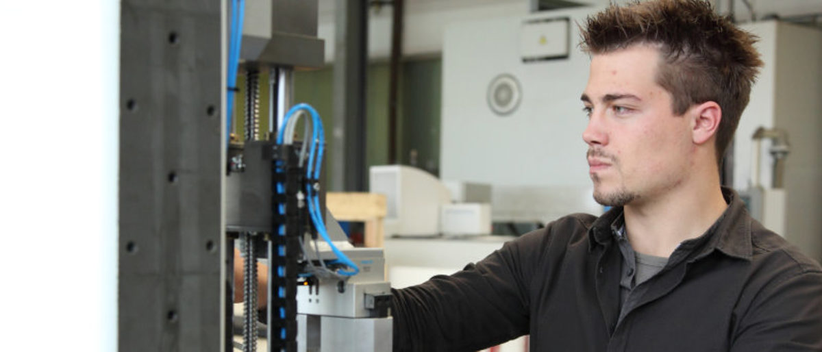 Unabhängige und ganzheitliche Beratung zu Erfindungen und Innovationen Junger Mann, Feinwerkmechaniker bei der Arbeit
