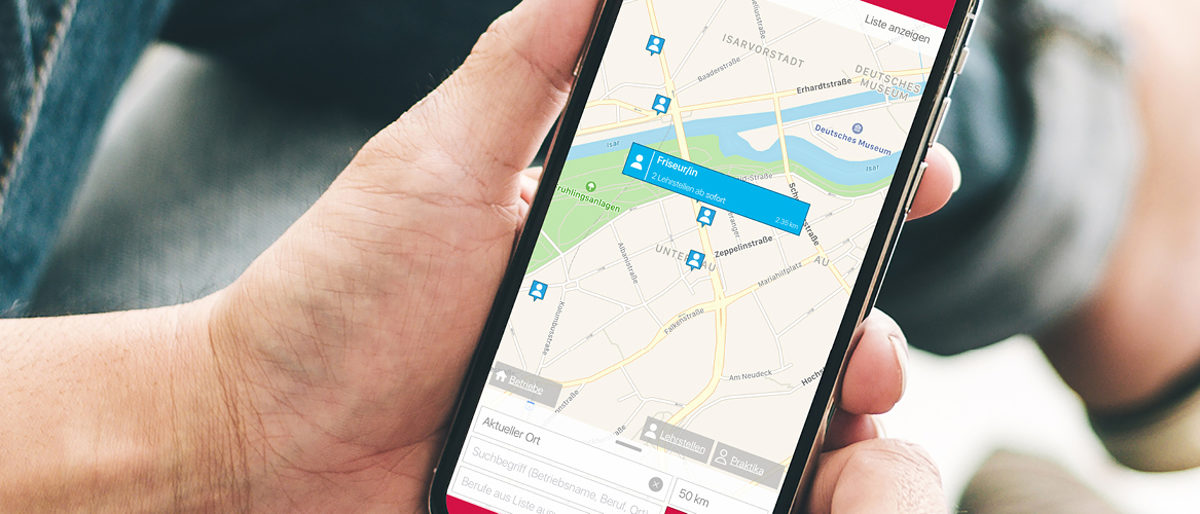 Mit der App Lehrstellenradar per Smartphone Ausbildungsplätze suchen. Eine Hand hält ein Smartphone. Auf dem Display ist eine Karte zu sehen, auf der Orte markiert sind.