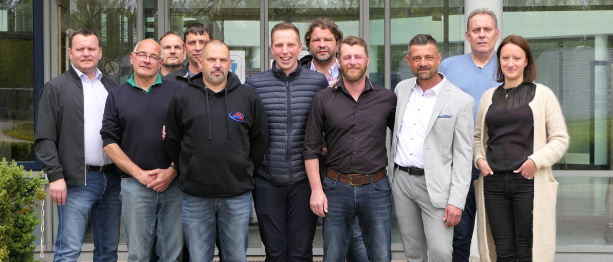 Dozenten und Absolventen freuen sich über die bestandenen Prüfungen zum Gebäudeenergieberater. Gruppenfoto mit zehn Männern und einer Frau.